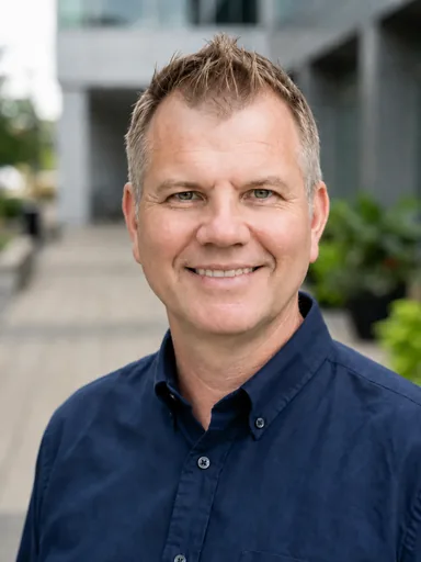 James Thompson, SEO and AiEO consultant, smiling outside an office building